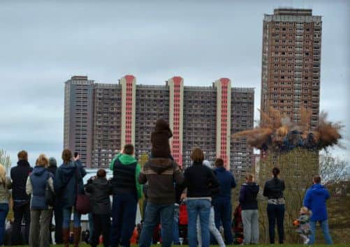 Onlookers watch as the tower block detonates. Picture: Getty