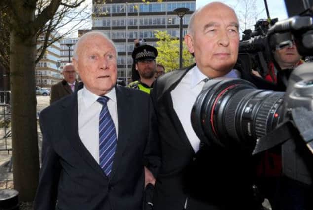 Former broadcaster Stuart Hall, left, is escorted from Preston Crown Court after last weeks admission of guilt. Picture: PA