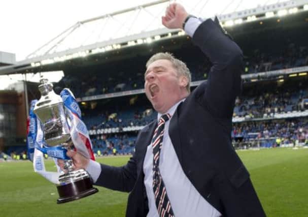 Rangers manager Ally McCoist celebrates with the Third Division trophy. Picture: SNS