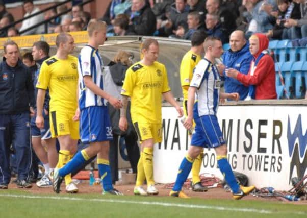 Players of both teams leave the pitch as the man is being treated. Picture: SNS
