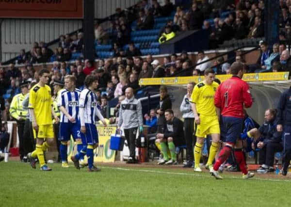 Kilmarnock and Hibs leave the field after play was abandoned. Picture: SNS