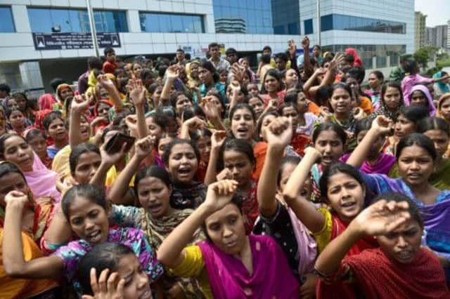 Garment workers in Dhaka shout slogans during a protest for better working conditions. Picture:AP