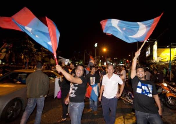 Supporters of opposition leader Anwar Ibrahim take to the streets after polls closed. Picture:AP