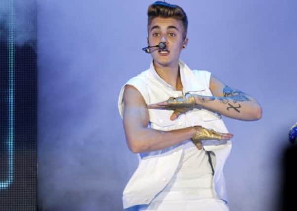 Canadian singer Justin Bieber performs on stage during a concert as part of his "Believe" World Tour at the Sevens Stadium in Dubai