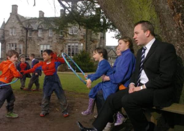 Clifton Hall head Rod Grant, with pupils in the school grounds, believes children are being written off. Picture: Jon Savage