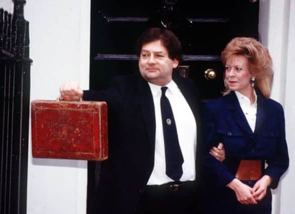 Lord Lawson holds up his red 'budget box' before he presents his 1989. Picture: PA