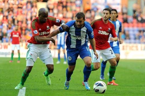 Wigan talisman Shaun Maloney struggles to escape the attentions of  Dwight Tiendalli. Picture: PA