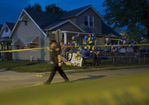 A police officer walks past the family home of Georgina DeJesus