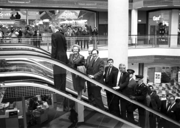 Going up: Margaret Thatcher accompanied by then Scottish Secretary Malcolm Rifkind at the opening of the St Enoch Centre in Glasgow in 1990. Photograph: Allan Milligan