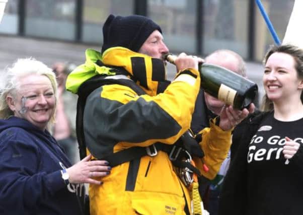 Gerry Hughes opens a bottle of Champagne with his wife Kathleen. Picture: PA