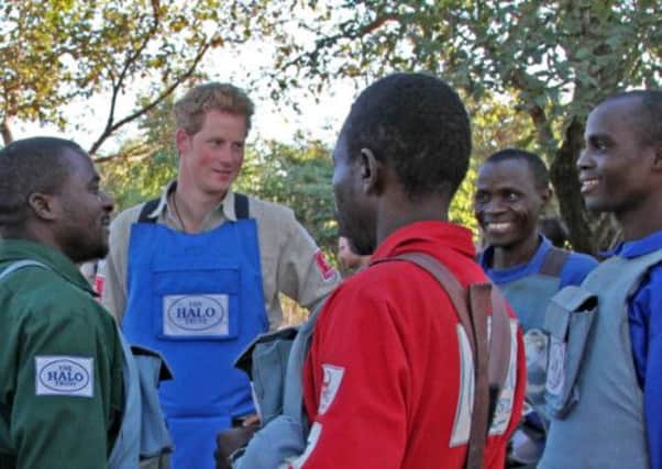 Prince Harry talking to HALO deminers during their work break in Mozambique. Picture: PA