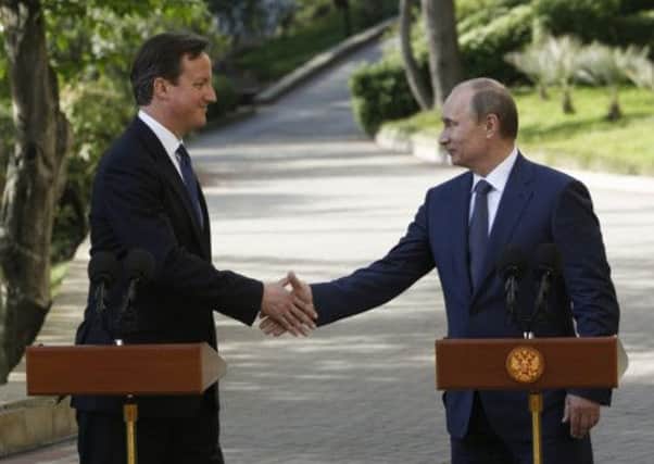 David Cameron and Vladimir Putin, giving a joint press conference in Sochi, Russia. Picture: AP