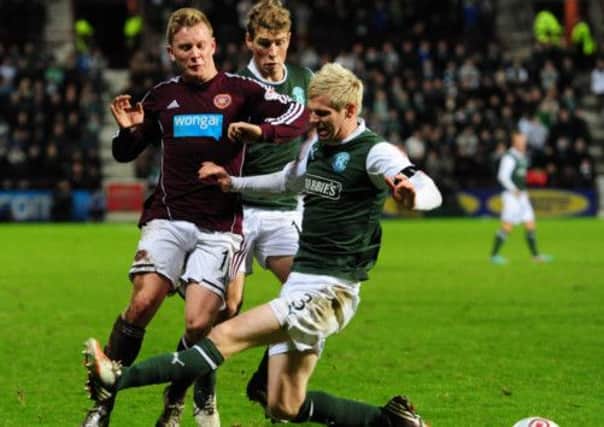 Hibs' Ryan McGivern tackles Hearts' Andrew Driver. Picture: Ian Rutherford