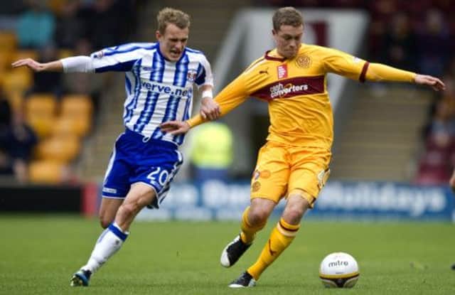 Motherwell's Nicky Law tries to break free of Dean Shiels (left). Picture: SNS