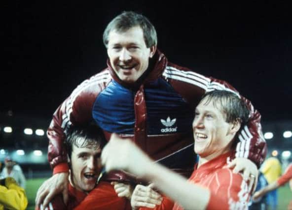 Alex Ferguson is hoisted aloft by Peter Weir and Doug Rougvie. Picture: SNS