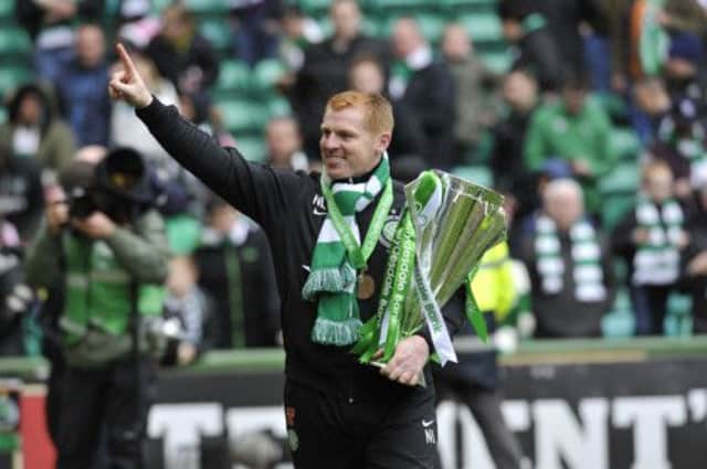 It's moments like this clutching the Premier League Trophy, that could keep Lennon at Parkhead for at least some time yet. Picture: Robert Perry