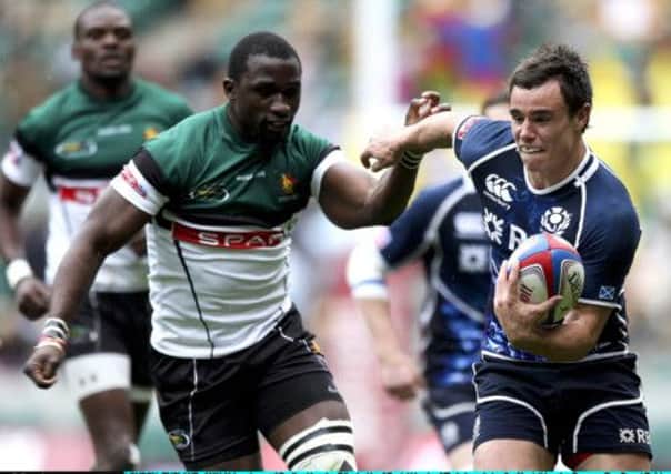Scottish try scorer Lee Jones evades the tackle of Zimbabwe's Daniel Hondo as the Scots fought back to score an unconvincing victory. Picture: Getty Images