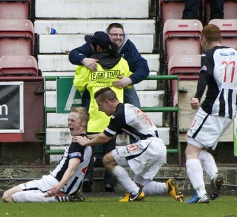 Dunfermline youngster Ross Millen celebrates his penalty, which took the tie to extra time. Picture: SNS