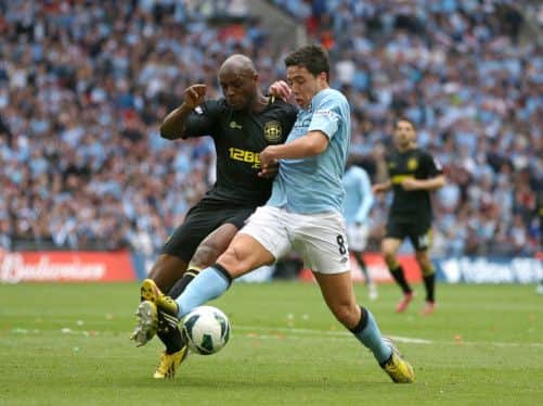 Samir Nasri and Emmerson Boyce battle for the ball.  Picture: PA