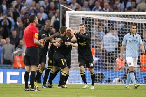 Ben Watson is mobbed by team-mates as he celebrates scoring the winning goal. Picture: PA