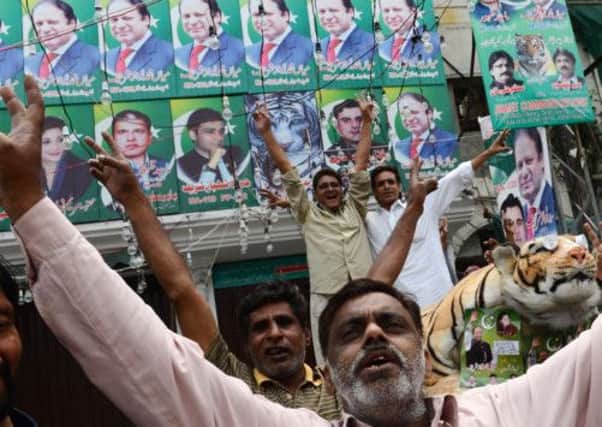 Supporters of former Pakistani prime minister and head of the Pakistan Muslim League-N (PML-N), Nawaz Sharif celebrate. Picture: Getty