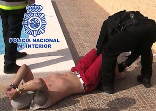 Police carry out the arrest in Alicante. Picture: PA