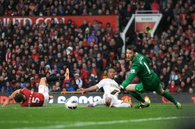 Manchester United goalkeeper David De Gea watches a shot from Swansea City's Wayne Routledge (centre) go just wide. Picture: PA