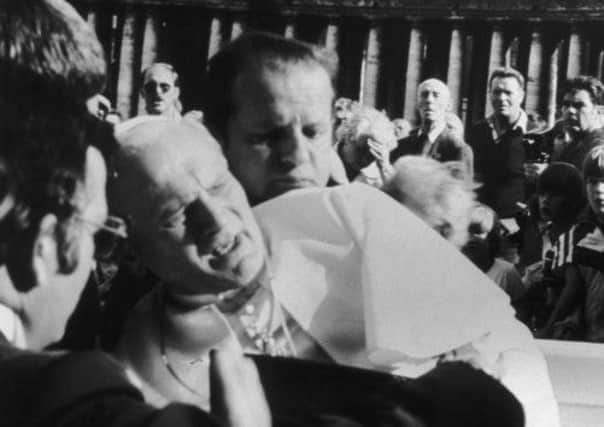 Pope John Paul II is in pain after being shot in an assassination attempt in St Peter's Square, Rome, on this day in 1981. Picture: Getty