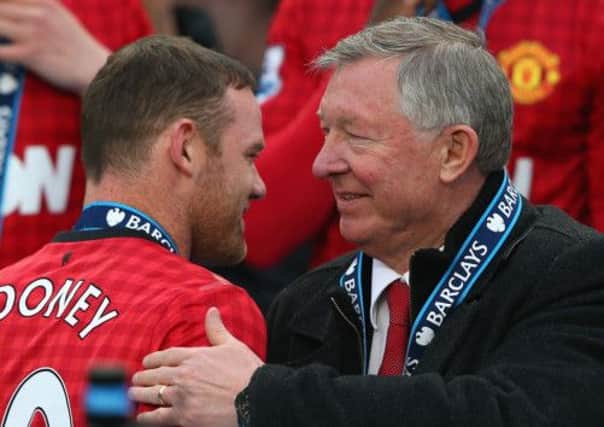 Wayne Rooney wasn't in the squad to face Swansea but was there at full-time to receive his title medal from Sir Alex Ferguson. Picture: Getty