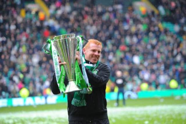 Celtic manager Neil Lennon with the SPL trophy at Parkhead following Saturday's 4-0 victory over St Johnstone. Picture: Robert Perry