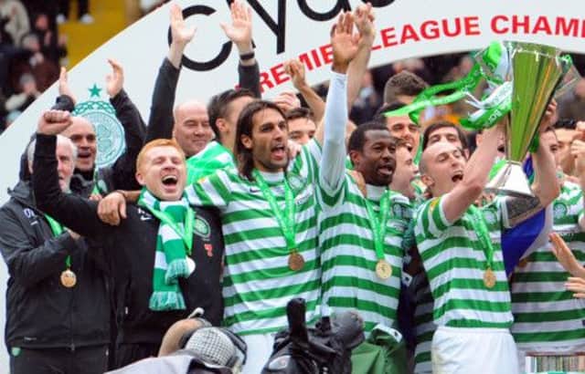 The jubilant Celtic squad are presented with the SPL trophy at full-time on Saturday. Picture: Robert Perry
