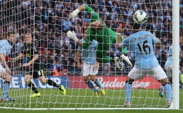 Wigan's Ben Watson scores a dramatic late winner past Manchester City goalkeeper Joe Hart in the FA Cup Final at Wembley. Picture: PA