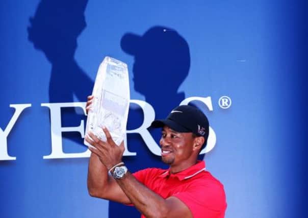 Tiger Woods lifts the trophy at Sawgrass, where he won his fourth title of 2013. Picture: Getty
