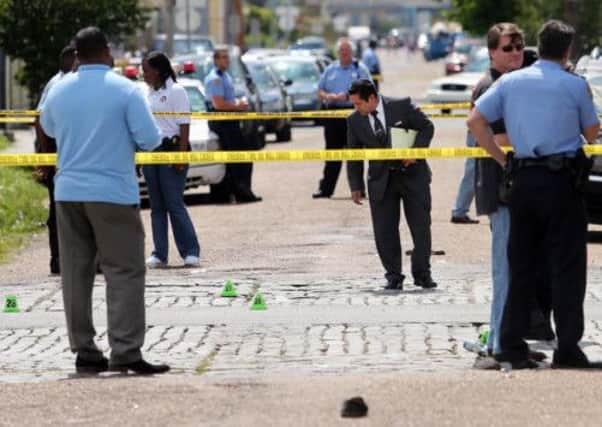 New Orleans police officers investigate the scene after yesterday's shooting. Picture: AP