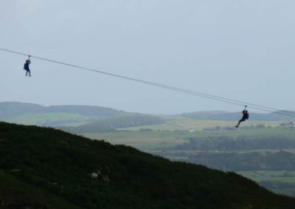 Taking in the views on a tandem zip wire ride. Picture: Contributed
