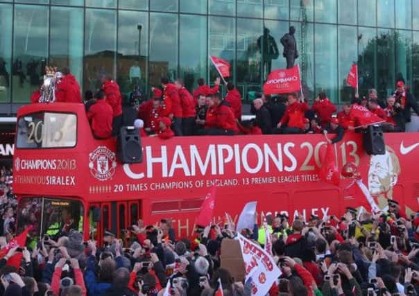 Players appear on the open topped bus outside Old Trafford during the Manchester United Premier League winners parade. Picture: Getty