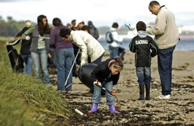 Volunteers help to pick up litter at Cramond Beach as part of the Beachwatch Big Weekend. Picture: Phil Wilkinson