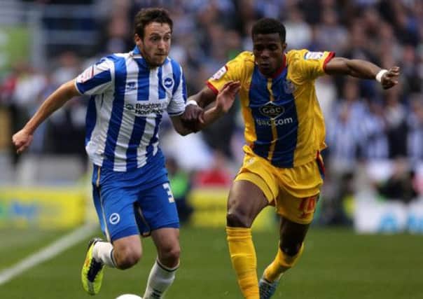 Crystal Palace matchwinner Wilfried Zaha battles Brighton's Will Buckley. Picture: PA