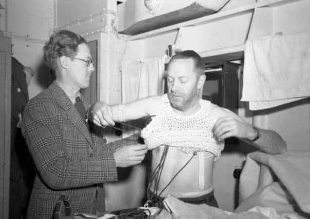Dr Griffith Pugh fits a skin temperature thermometer to a member of the Royal Canadian Navy in March 1949.  Picture: AP