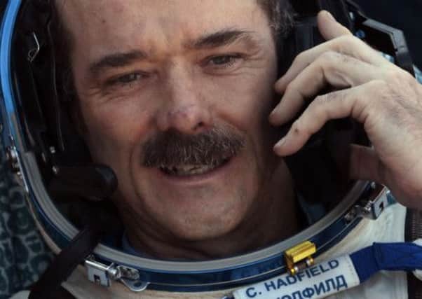 Cmdr Chris Hadfield speaks on the phone shortly after the Soyuz space capsule landed in Kazakhstan. Picture: AP