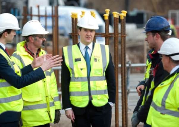 Chancellor George Osborne with construction workers at a development in London. Picture: Getty