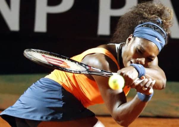 Serena Williams hits a shot past Laura Robson. Picture: Reuters