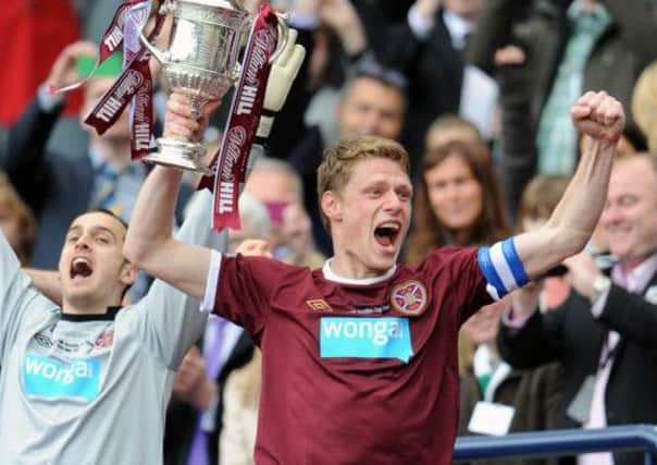 Marius Zaliukas lifts the Scottish Cup. Picture: Ian Rutherford