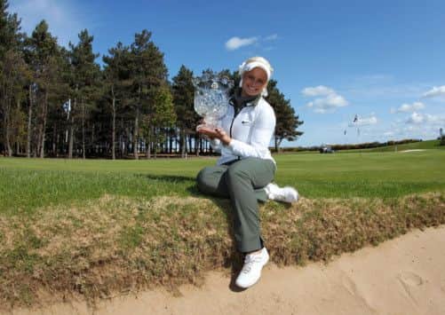 Scotland's Carly Booth with the Asset Management Ladies Scottish Open trophy. Picture: PA