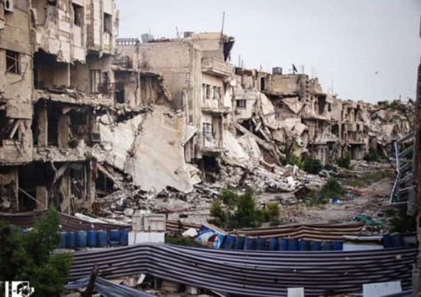 Buildings after a shelling attack, purportedly by pro-government forces in Homs. Picture: AP/Lens Young Homsi
