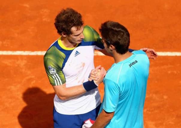 Murray shakes hands with Marcel Granollers after retiring injured. Picture: Getty