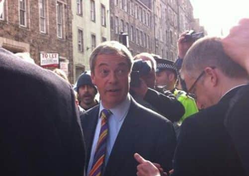 A flustered Nigel Farage is surrounded by journalists, protestors and police. Picture: Euan McColm
