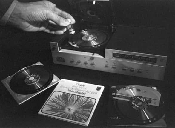 On this day in 1978 Philips created compact discs. A technician gives a demonstration of how they work. Picture: Getty
