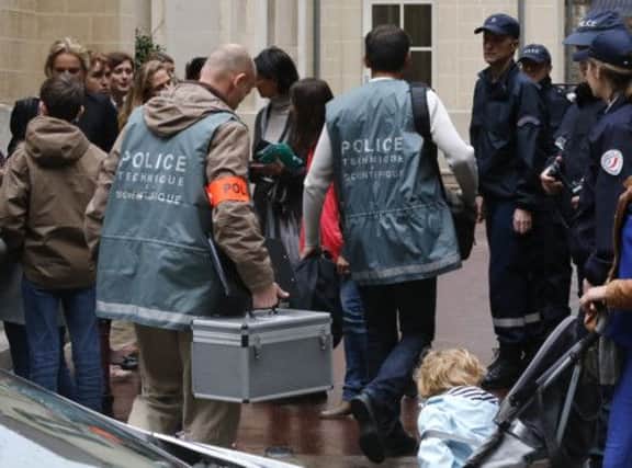 Forensics arrive after a man committed suicide at a school in central Paris. Picture: AP