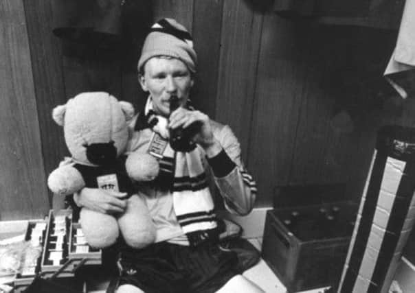 Davie Dodds, a mascot bear and a bottle of beer following Dundee Uniteds league-clinching win at Dens Park. Picture: Denis Straughan